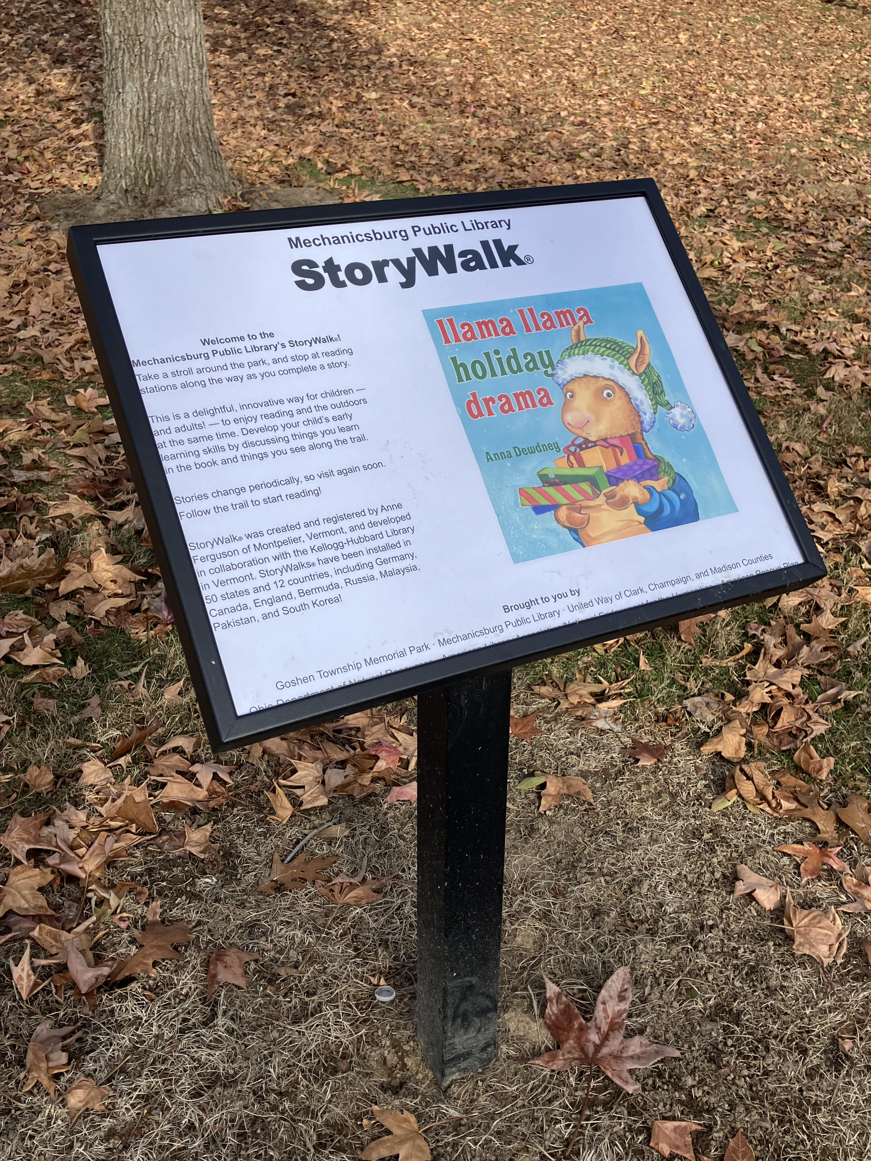 Story Walk sign post with the cover page of the book Llama Llama Holiday Drama